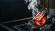 © Amanah Ajha - Glowing hot sauna stone with steam in dark wooden room
