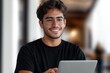 © Milana - person with blurred face and curly hair in black t-shirt working on a laptop in a modern blurred office corridor, appearing focused
