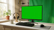 © Kang - Computer monitor with chroma key green screen on desk with keyboard and mouse in home office for gaming streaming broadcast