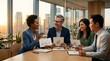 © Dilan - Diverse business team discussing renewable energy ideas in an office