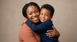 © Sang - Happy mother and young son smiling and hugging in a studio portrait