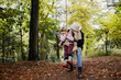 © Westend61 - Grandmother swinging child on rope swing in autumn forest