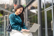 © Art_Photo - Blogger smiling asian woman working on laptop outdoors in green park, Freelance digital nomad woman writing online content, e-learning, Modern remote work internet and work life balance concepts