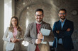 © Novak - Portrait of three diverse business people standing in modern office