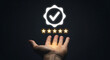 © Zain khan - Hand holding a glowing checkmark icon with five stars in a dark background