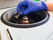 © Dirk - Laboratory technician loading a microcentrifuge tube into a laboratory centrifuge rotor for DNA extraction and GMO sample preparation