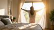 © Emre Akkoyun - Woman waking up in sunny bedroom, opening curtains and enjoying sunrise light, embracing new day and warmth at home