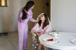 © millaf (Nemchinova) - Attractive little girl in pink pajamas with her mom eating in kitchen