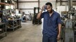 © Xenia - African American male worker wiping sweat from forehead indoors. Tired mechanic in a hot industrial workshop. Heatwave theme
