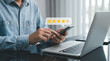 © Abuzar - Customer review good rating feedback concept, A person using a smartphone to leave a 5-star review, with emphasizing online feedback. testimonial and testimony, user comment and feedback for review.
