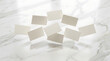 © Bilah - Business cards drift across a bright marble floor to offer an airy template for custom brand identity designs.