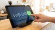 © SABYDA - Hand touching happy face emoji on tablet screen for customer feedback survey satisfaction