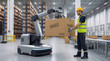 © ChaoticDesignStudio - Logistics worker monitoring robotic arm lifting cardboard box in distribution center. Human-robot collaboration in automated warehouse.