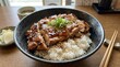 © Iqra - Grilled teriyaki chicken thighs served with steamed white rice and garnish.