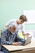 © New Africa - Teenage boy helping elderly man learn how to use laptop at table indoors. Modern technology for seniors