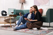 © New Africa - Date. Couple listening to vinyl record at home