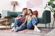 © New Africa - Date. Couple with glasses of wine listening to vinyl record at home