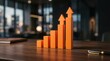 © Masque - Orange bar graph with upward arrows showing positive growth and success on a wooden desk.