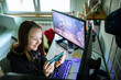 © Davor - Teen girl gaming on smartphone at home desk
