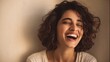 © Gajah - Beautiful woman with curly hair laughing with eyes closed