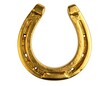 © Kedelai - Close-up of a golden horseshoe isolated against a white background. It symbolizes luck and fortune