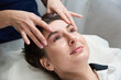 © Maria - Beautiful Young Woman Getting a Face and head Treatment at Beauty Salon
