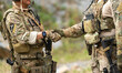 © Wosunan - Military personnel communicate and coordinate during a field operation briefing