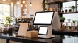 © Image - Modern digital display terminal on a cafe counter with wooden box and plants