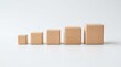 © anamulsh - Wooden blocks increasing in size on white background growth development progression scale step.