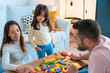 © ManuPadillaPhoto - Happy family playing together in the living room