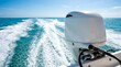 © Design Store - White outboard boat motor operating in turquoise blue ocean water leaving foamy white wake trails on sunny clear day.