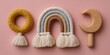 © Marina Demidiuk - Macrame rainbow weave with wooden rattle and moon crescent toy for infant baby on pink background. Nursery design marketing product advertising banner, Scandinavian style children goods template.