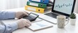 © Moolecule Studio - Businessman in protective gloves using calculator and laptop to analyze financial data on office desk