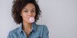 © MdMoinul - a beautiful african american woman blowing a pink bubble gum, white background