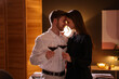 © New Africa - Date. Lovely couple with glasses of red wine at home