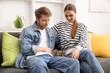 © New Africa - Couple with their cute cat on sofa at home