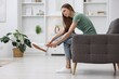 © New Africa - Woman suffering from leg pain on armchair at home, space for text