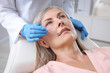 © New Africa - Dentist checking woman's teeth in clinic, closeup