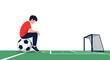 © Rakhi - Sad young boy in red shirt sitting on black and white soccer ball looking down towards empty goal on green field.