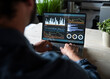 © Westend61 - Financial specialist working on laptop with data charts in office