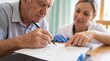 © Megin Design - Close up of elderly man taking clock drawing cognitive test. Female doctor guiding senior patient during dementia assessment. Alzheimer diagnostic and mental health care concept
