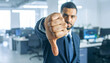 © lloyd - Businessman showing thumbs down gesture, expressing disapproval, rejection or negative feedback in a professional setting