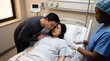 © Philipp - Pregnant woman in hospital bed comforted by partner with nurse attending, childbirth support