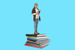 © New Africa - Senior woman standing on stack of books. Light blue background