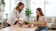 © Mahfud Picture - Nutritionist discussing healthy meal planning and fresh ingredients with a young patient in a bright office