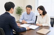 © AiPhoto - 会議室で相談書類を確認するシニア夫婦