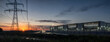 © ultramcu - Power grid feeding modern data center at dusk