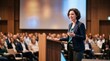 © Azorahaiá - Confident Woman Speaker Gesturing While Presenting to Audience at Conference or Seminar