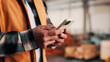 © peopleimages.com - Carpentry, hands and phone with man in warehouse for feedback, management or planning. App, communication and space with person in woodworking factory for furniture manufacturing or production