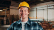 © peopleimages.com - Carpentry, portrait and happy man in factory with helmet, handyman or ambition in manufacturing industry. Smile, hardhat or carpenter with about us, production career or confidence in woodworking.